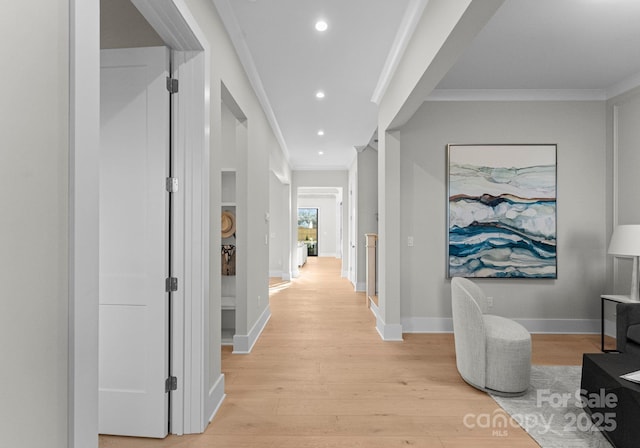 hallway with ornamental molding, recessed lighting, baseboards, and light wood finished floors