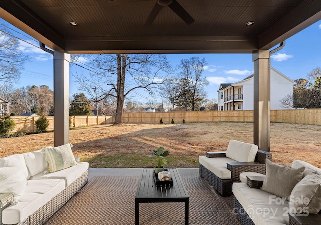 view of patio with outdoor lounge area, ceiling fan, and a fenced backyard