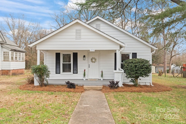 bungalow-style house with a porch and a front lawn