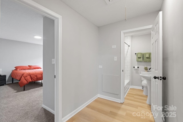 corridor featuring wood-type flooring and a textured ceiling