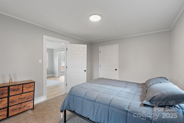 bedroom with crown molding and carpet flooring