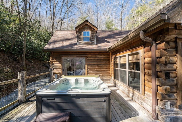 wooden terrace featuring a hot tub and a grill