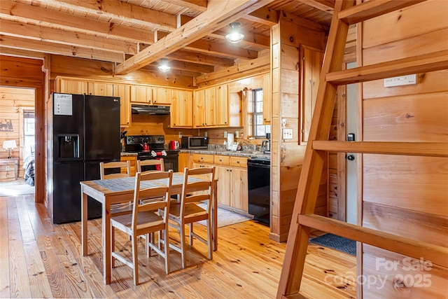 kitchen with light wood-type flooring, black appliances, under cabinet range hood, and light brown cabinetry