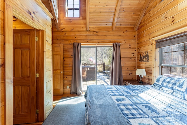 carpeted bedroom featuring access to exterior, wooden walls, and multiple windows