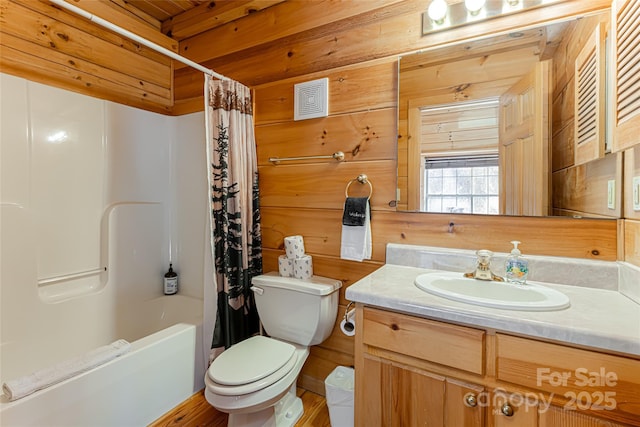 full bath featuring shower / bath combo, visible vents, toilet, vanity, and wood walls