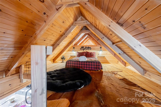 bedroom with wooden ceiling, wooden walls, and lofted ceiling with beams