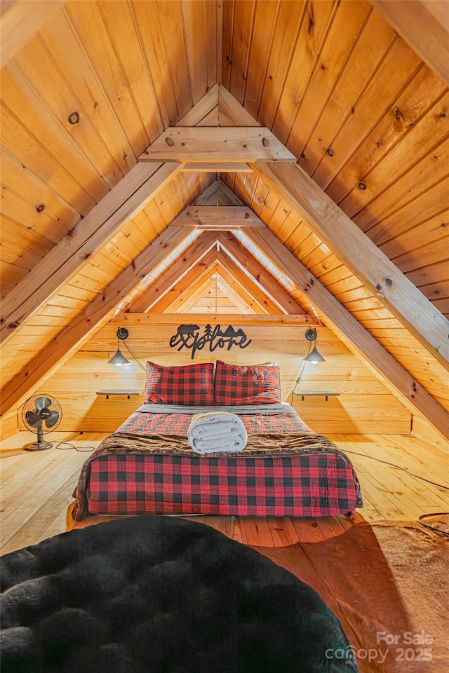 bedroom featuring vaulted ceiling with beams, wood walls, and wood ceiling