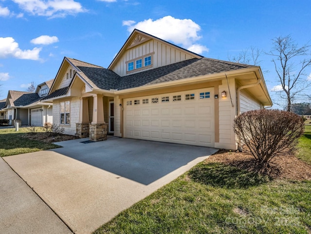 view of front of house with an attached garage, a shingled roof, concrete driveway, stone siding, and board and batten siding