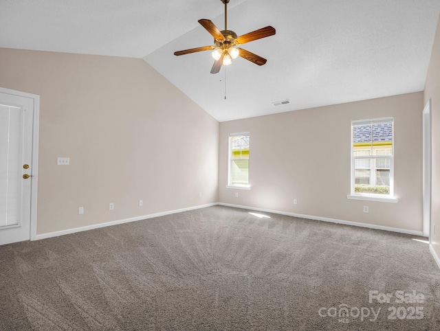 carpeted empty room featuring visible vents, baseboards, lofted ceiling, and ceiling fan