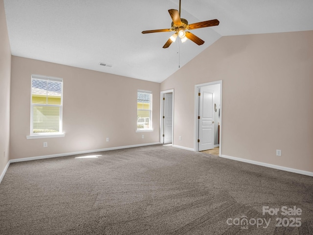 carpeted spare room with visible vents, baseboards, a ceiling fan, and vaulted ceiling