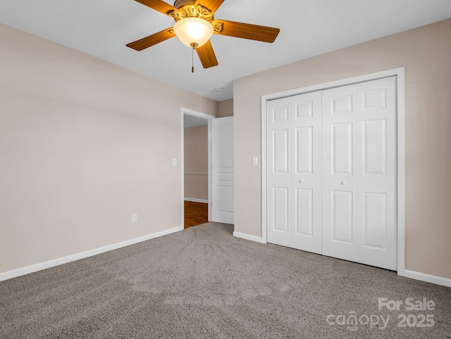 unfurnished bedroom with baseboards, carpet floors, a closet, and a ceiling fan