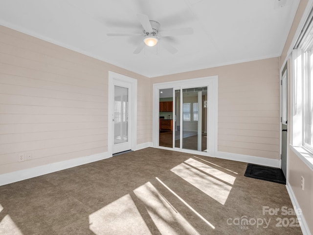 unfurnished sunroom featuring ceiling fan