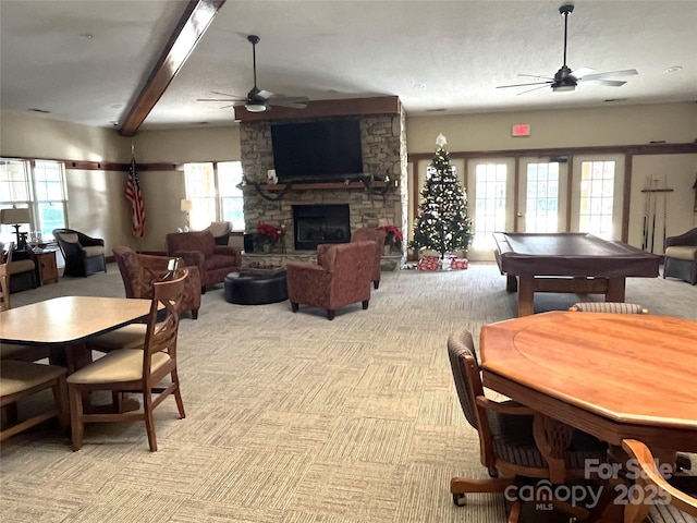 dining room with light colored carpet, pool table, a fireplace, and a ceiling fan