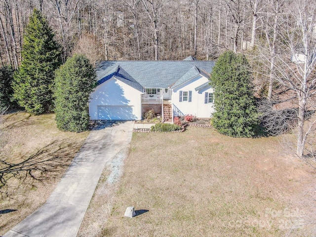 view of front of house with a garage and a front lawn