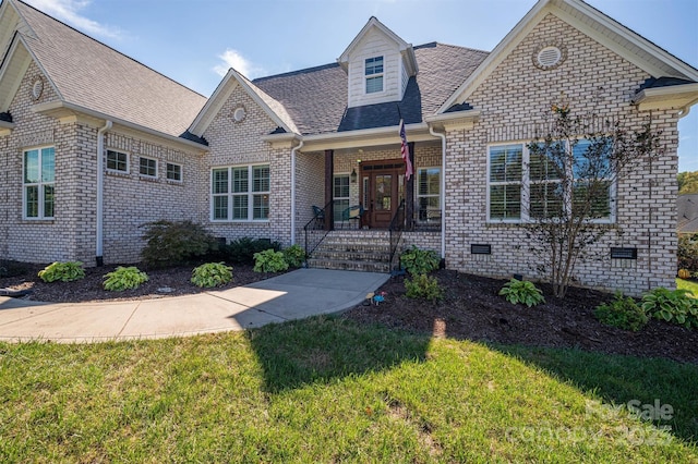 view of front of home featuring crawl space, brick siding, roof with shingles, and a front lawn