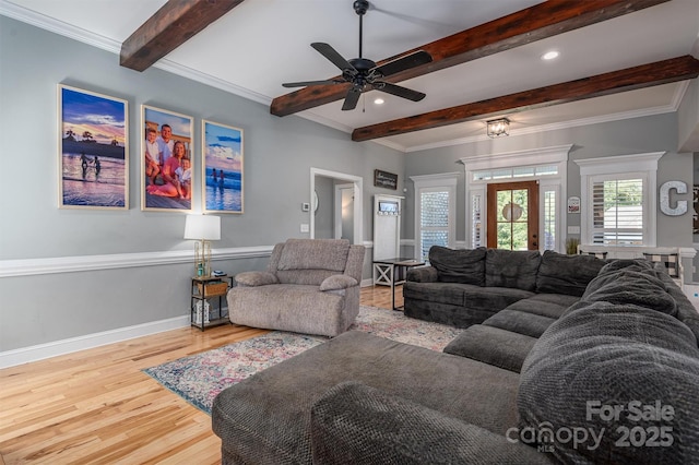 living room with beamed ceiling, wood finished floors, baseboards, and ornamental molding