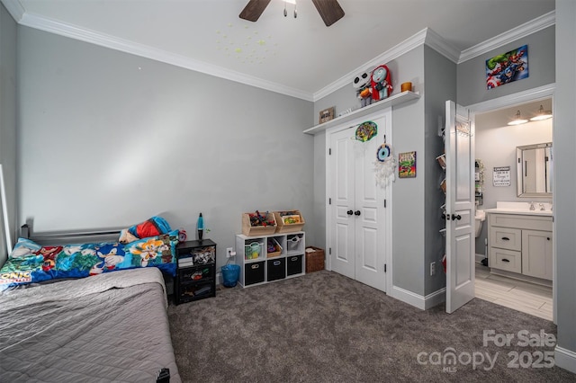 carpeted bedroom featuring ceiling fan, a sink, ornamental molding, a closet, and connected bathroom