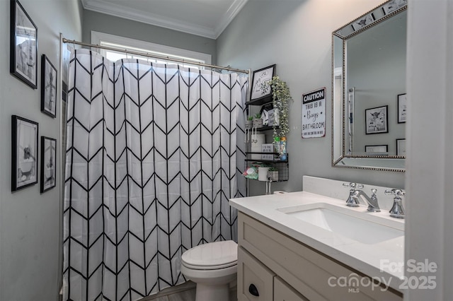 bathroom featuring toilet, ornamental molding, vanity, and curtained shower