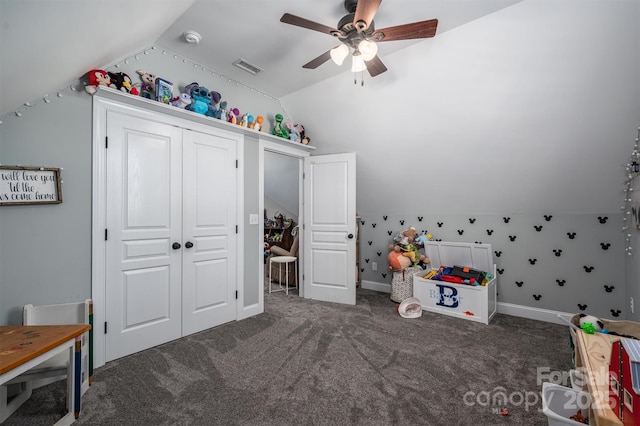 game room with lofted ceiling, ceiling fan, and dark colored carpet