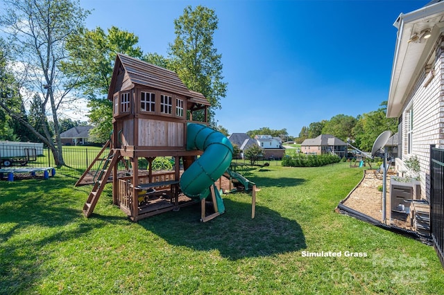 view of play area with a lawn and fence