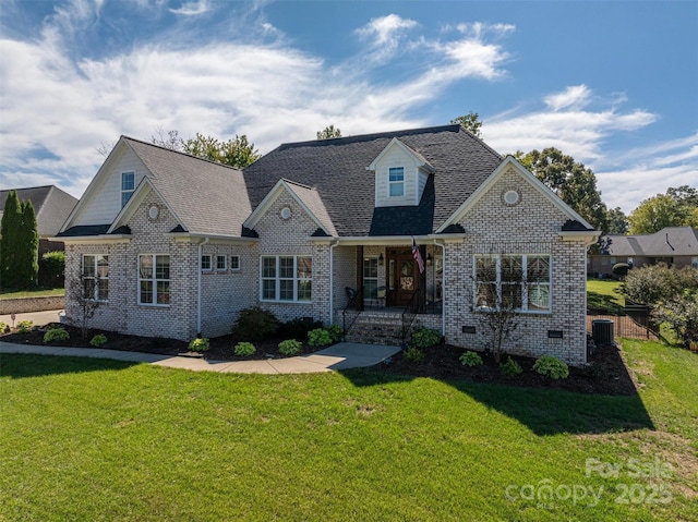 view of front of property with covered porch, a front yard, and central AC unit