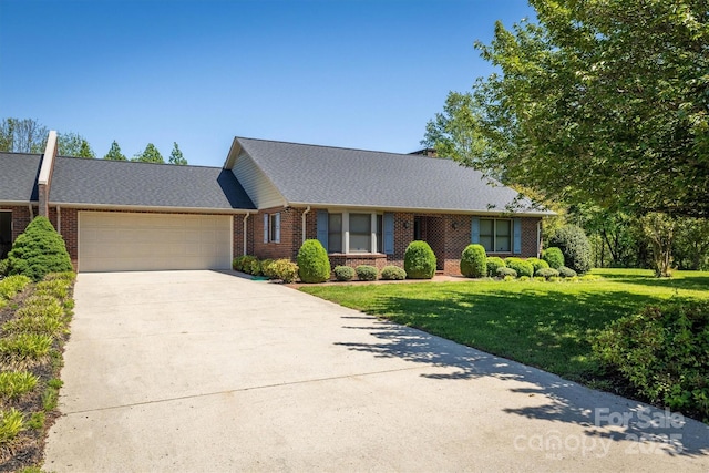 ranch-style home with driveway, a front yard, a garage, brick siding, and a shingled roof