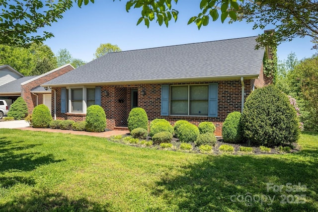 single story home with brick siding, a front lawn, and a chimney