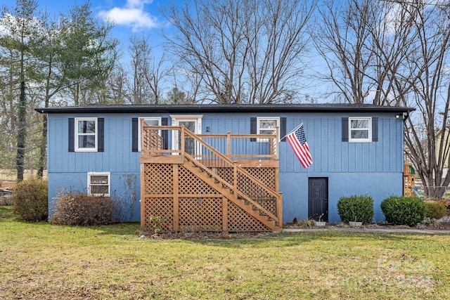 view of front of home with a front lawn and a wooden deck