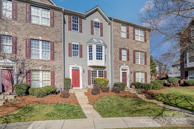 view of property featuring brick siding