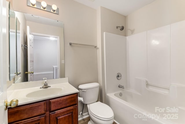 full bathroom featuring bathing tub / shower combination, vanity, and toilet