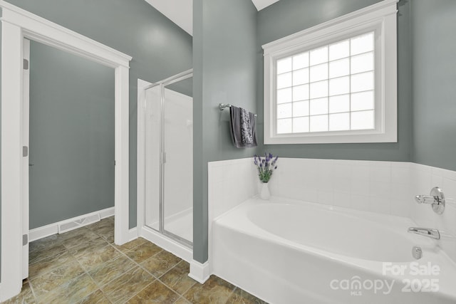 bathroom with visible vents, a garden tub, baseboards, and a stall shower