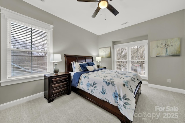 bedroom featuring baseboards, a ceiling fan, visible vents, and light carpet