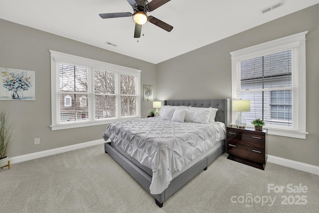 bedroom featuring baseboards, visible vents, and light carpet