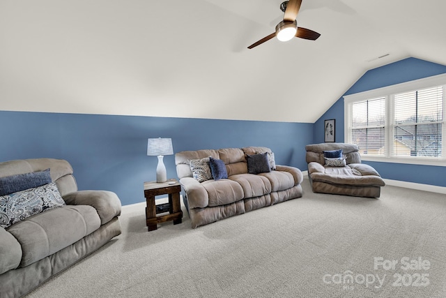 carpeted living room featuring baseboards, lofted ceiling, and a ceiling fan