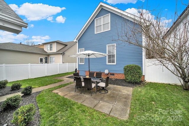 back of house with a patio area, a fenced backyard, a yard, and crawl space