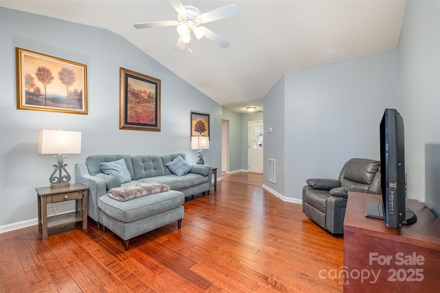 living room with visible vents, lofted ceiling, light wood finished floors, baseboards, and ceiling fan