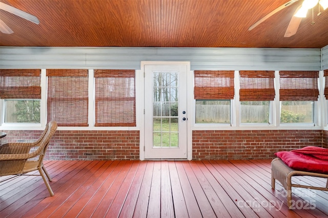 sunroom / solarium featuring wood ceiling and a ceiling fan