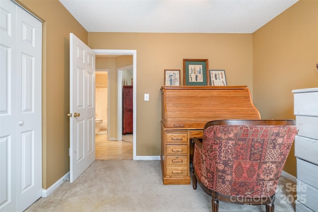 carpeted office featuring baseboards