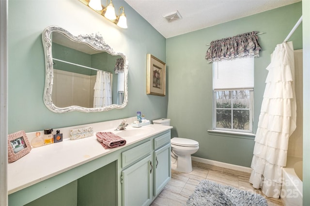 bathroom with visible vents, baseboards, toilet, and vanity