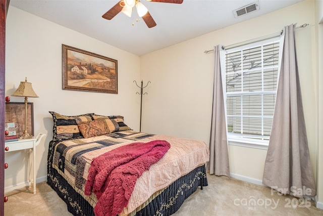 bedroom featuring light carpet, visible vents, ceiling fan, and baseboards