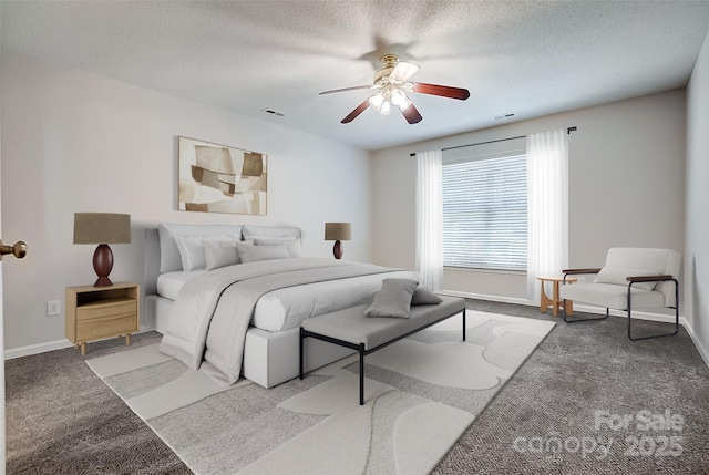 carpeted bedroom featuring baseboards, visible vents, and a textured ceiling