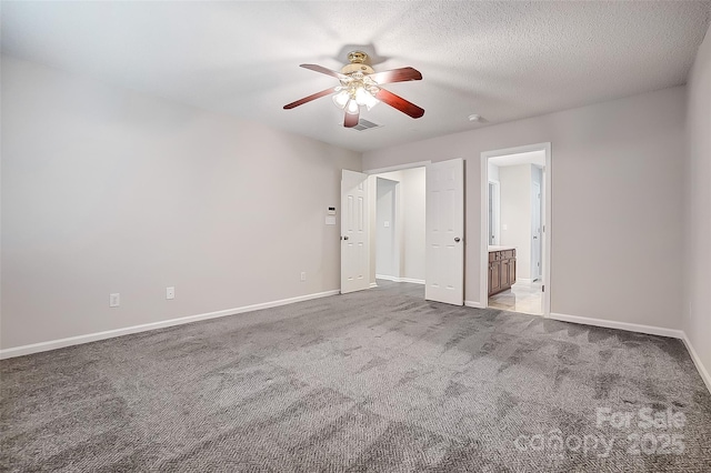 unfurnished bedroom featuring visible vents, light carpet, a textured ceiling, and baseboards