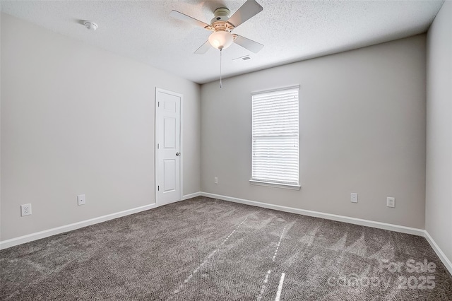 carpeted spare room featuring a ceiling fan, baseboards, visible vents, and a textured ceiling