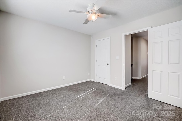 unfurnished bedroom featuring ceiling fan, dark carpet, and baseboards