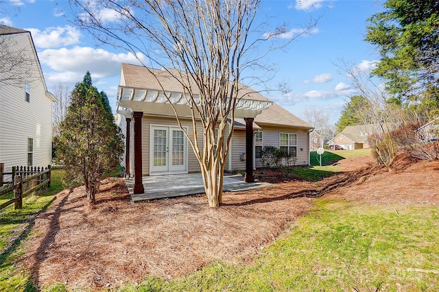 rear view of property with fence, a patio, and french doors