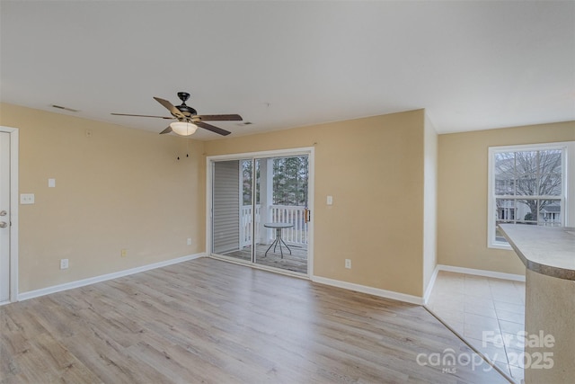 unfurnished room with ceiling fan and light hardwood / wood-style flooring