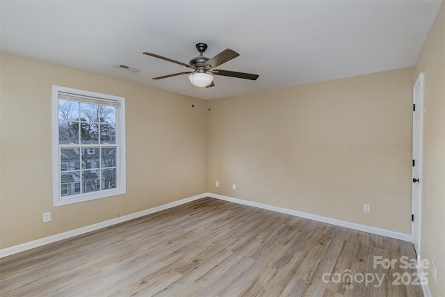 spare room with light hardwood / wood-style flooring and ceiling fan