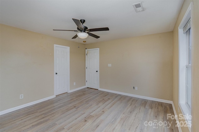 spare room featuring ceiling fan and light hardwood / wood-style flooring