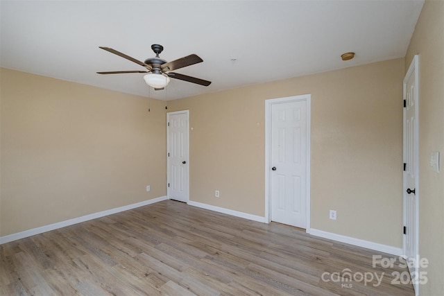 spare room featuring ceiling fan and light hardwood / wood-style floors