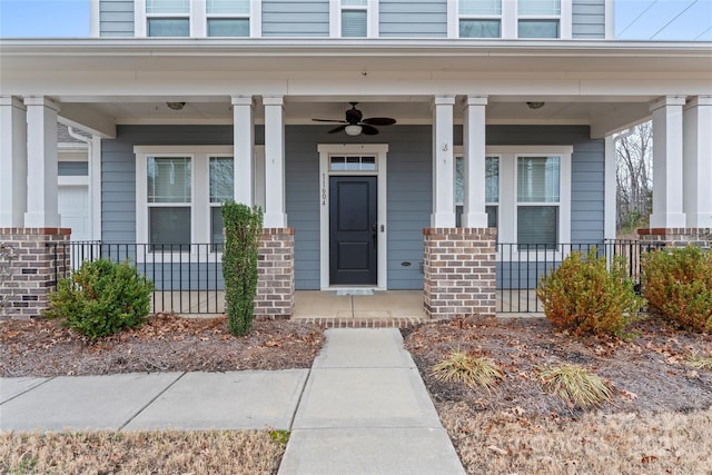 entrance to property with a porch and ceiling fan